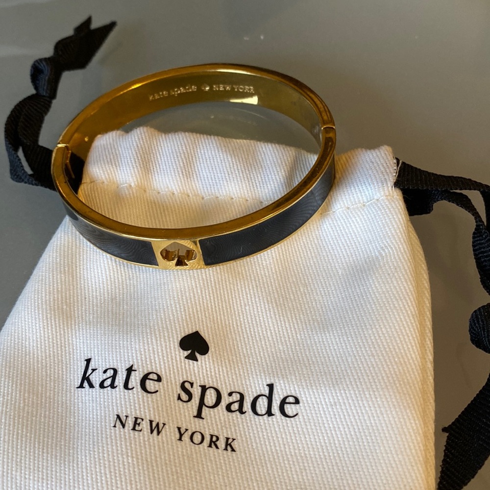 Kate Spade signature icon bangle bracelet.  Black with gold trim. Clasp.